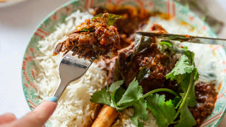 Oven roasted lamb shank curry with green herb yoghurt sauce